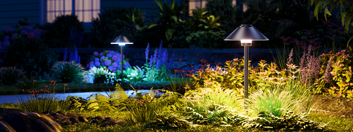 Decktok Smart Mushroom Path Light with sleek black aluminum finish, illuminating a garden walkway with bright warm white LED light.