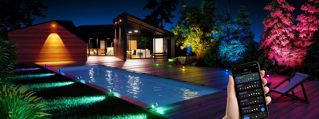 Smart outdoor spotlights lighting pool and backyard landscape with RGB colors, controlled via mobile app
