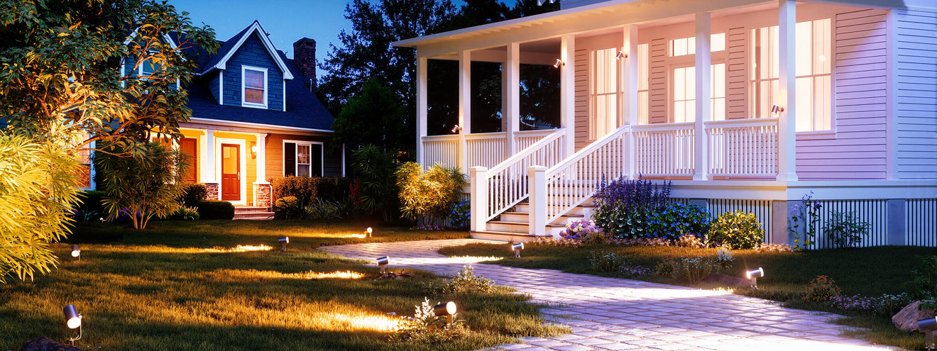Outdoor spotlights highlighting front yard lawn and walkway for safe and decorative landscape lighting