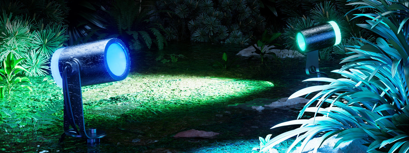 Waterproof outdoor spotlight projecting focused RGB light onto garden plants for landscape accent lighting