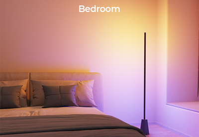 Decktok RGBWW Smart Corner Floor Lamp in a living room gaming setup, projecting cool blue and pink gradient light next to a TV.