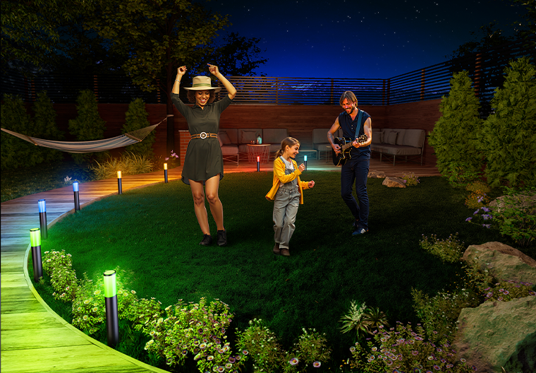 Smart pathway lights providing natural white lighting for backyard family activities