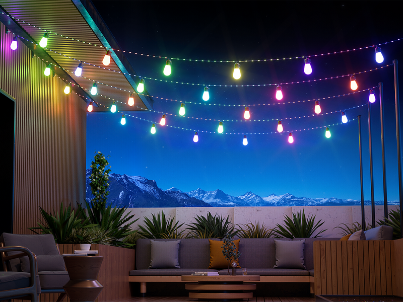 Smart outdoor string lights illuminating patio and rooftop seating area at night