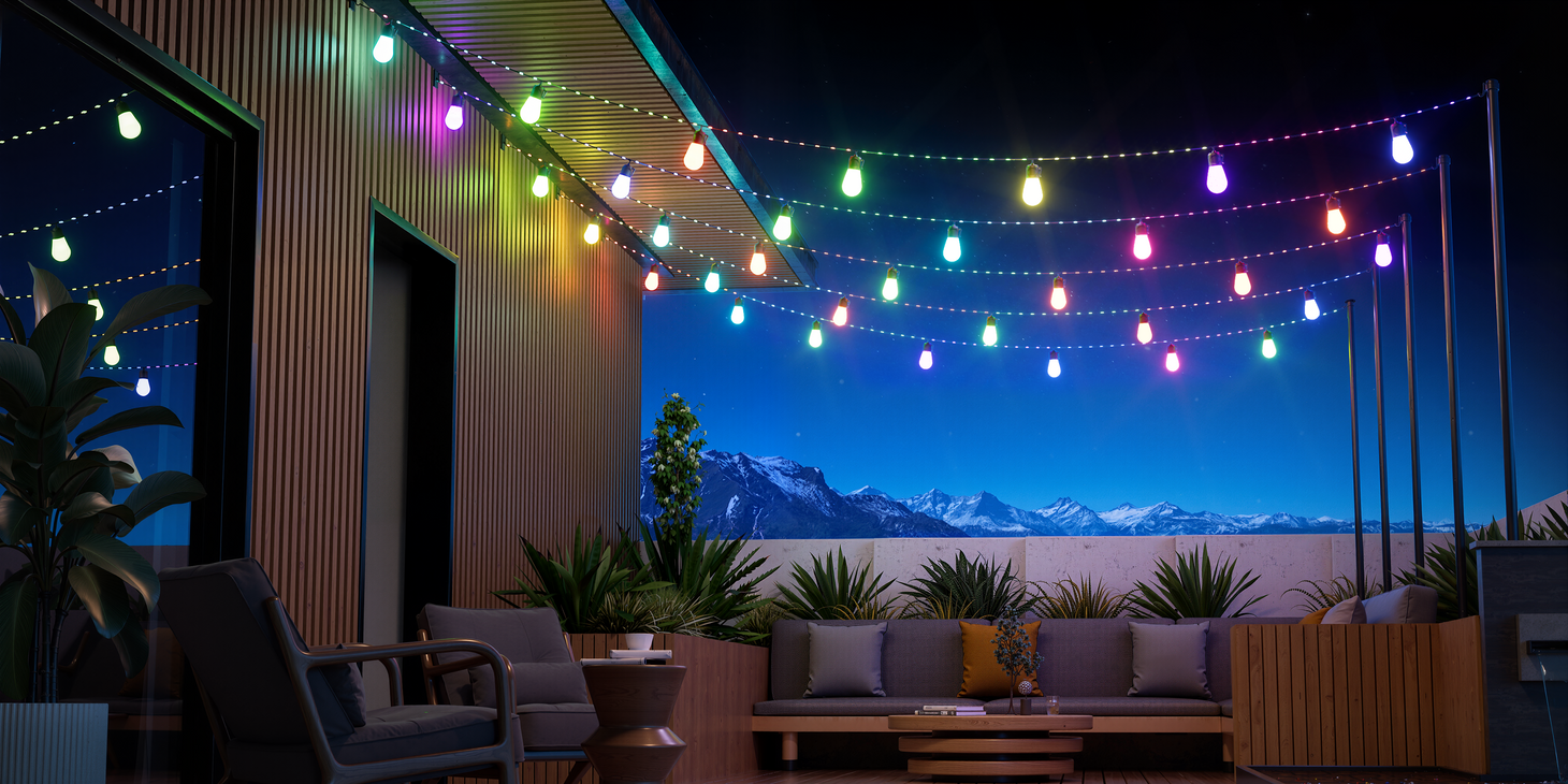 Smart outdoor string lights illuminating patio and rooftop seating area at night