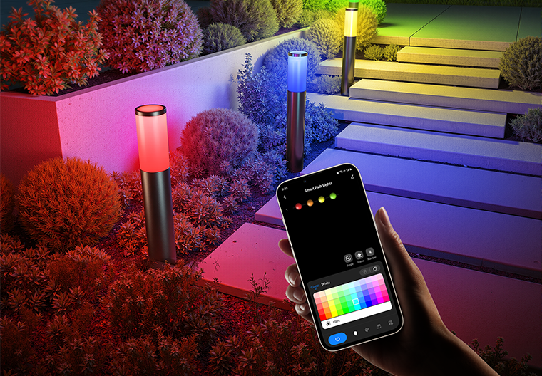 Smart pathway lights illuminating modern home landscape with multicolor lighting