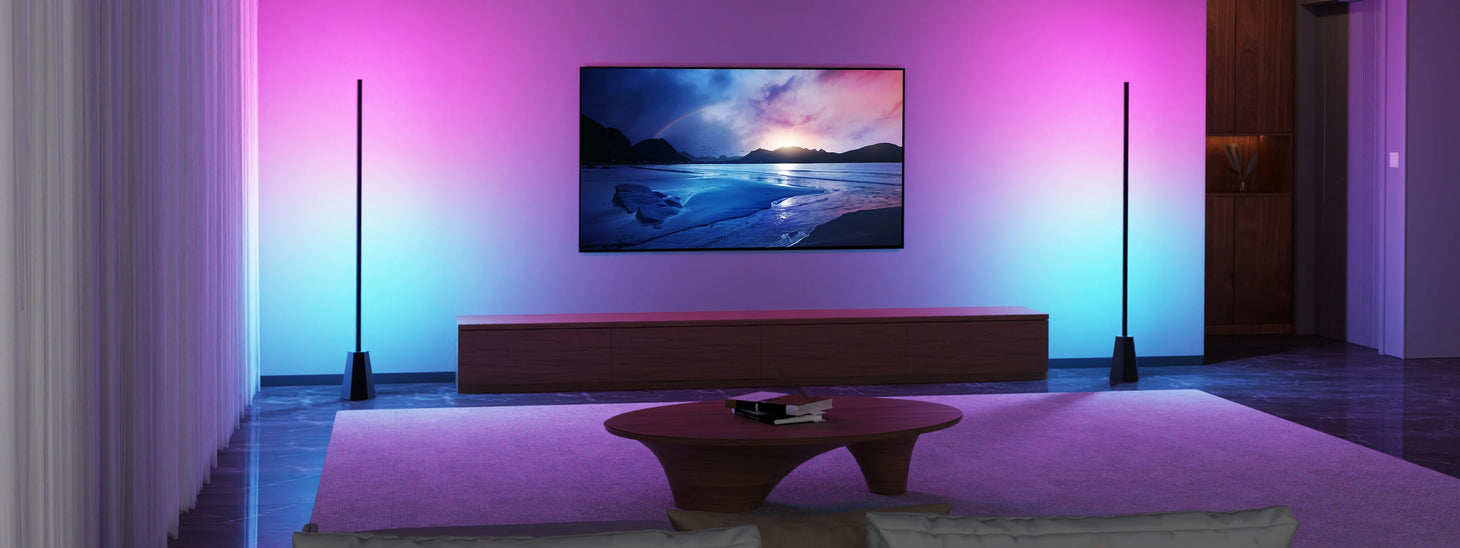 Two Decktok RGBWW Smart Corner Floor Lamps placed on either side of a television in a modern living room, projecting vibrant gradient light of purple, pink, and blue colors onto the back wall, enhancing the home entertainment atmosphere